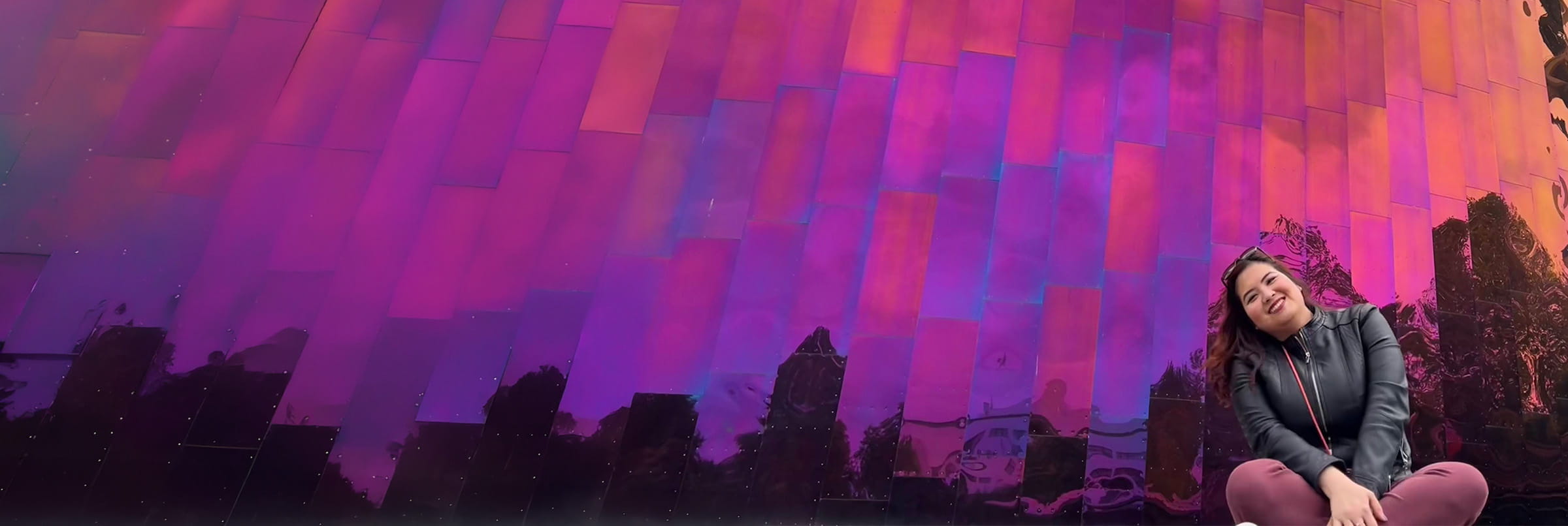 Gloria seating in front of colorfull building